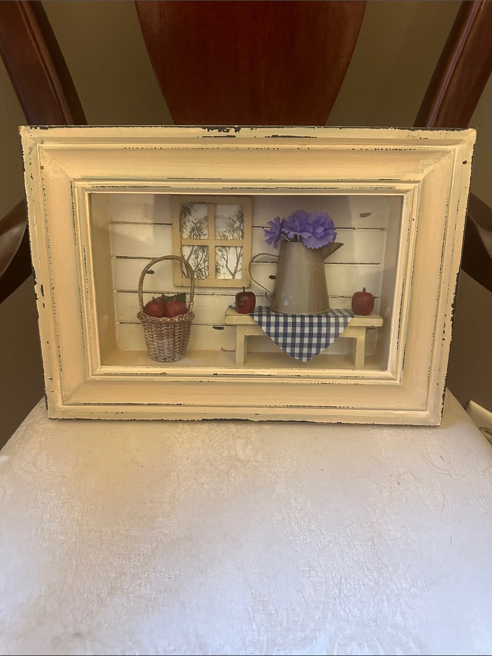 Rustic farmhouse scene with basket of apples and pitcher of flowers in 3D